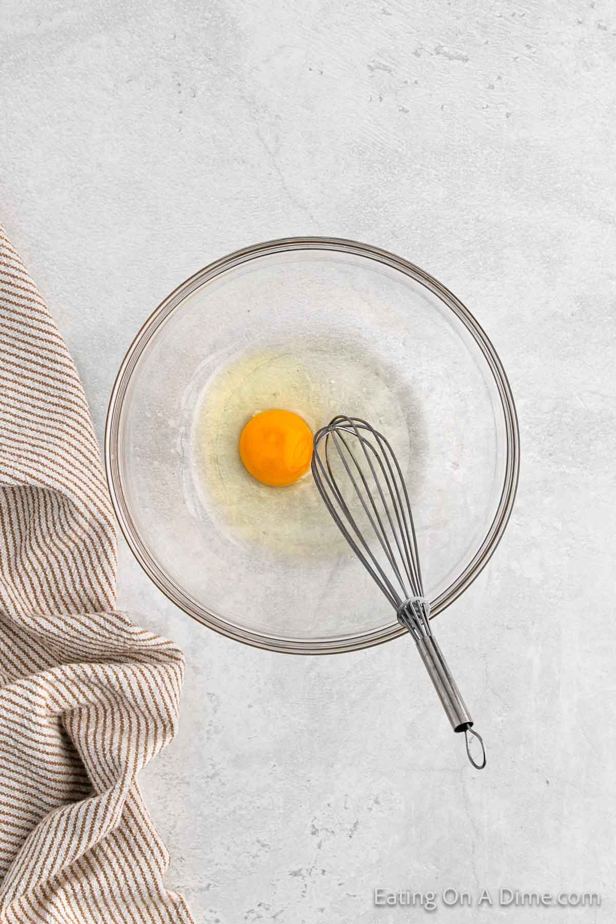 Combine egg and water in a bowl with a whisk