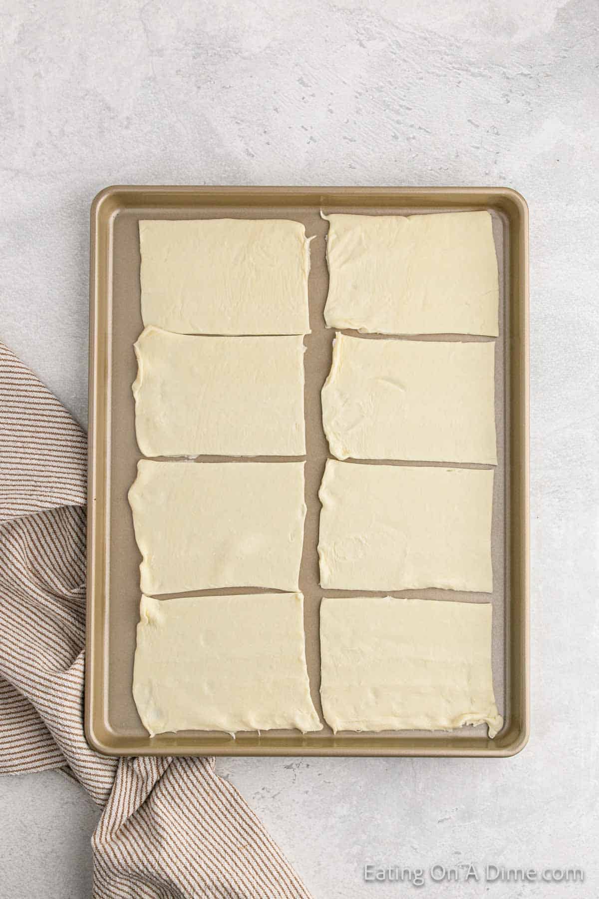 Puff pastry sheets cut into 8 squares placed on a baking sheet