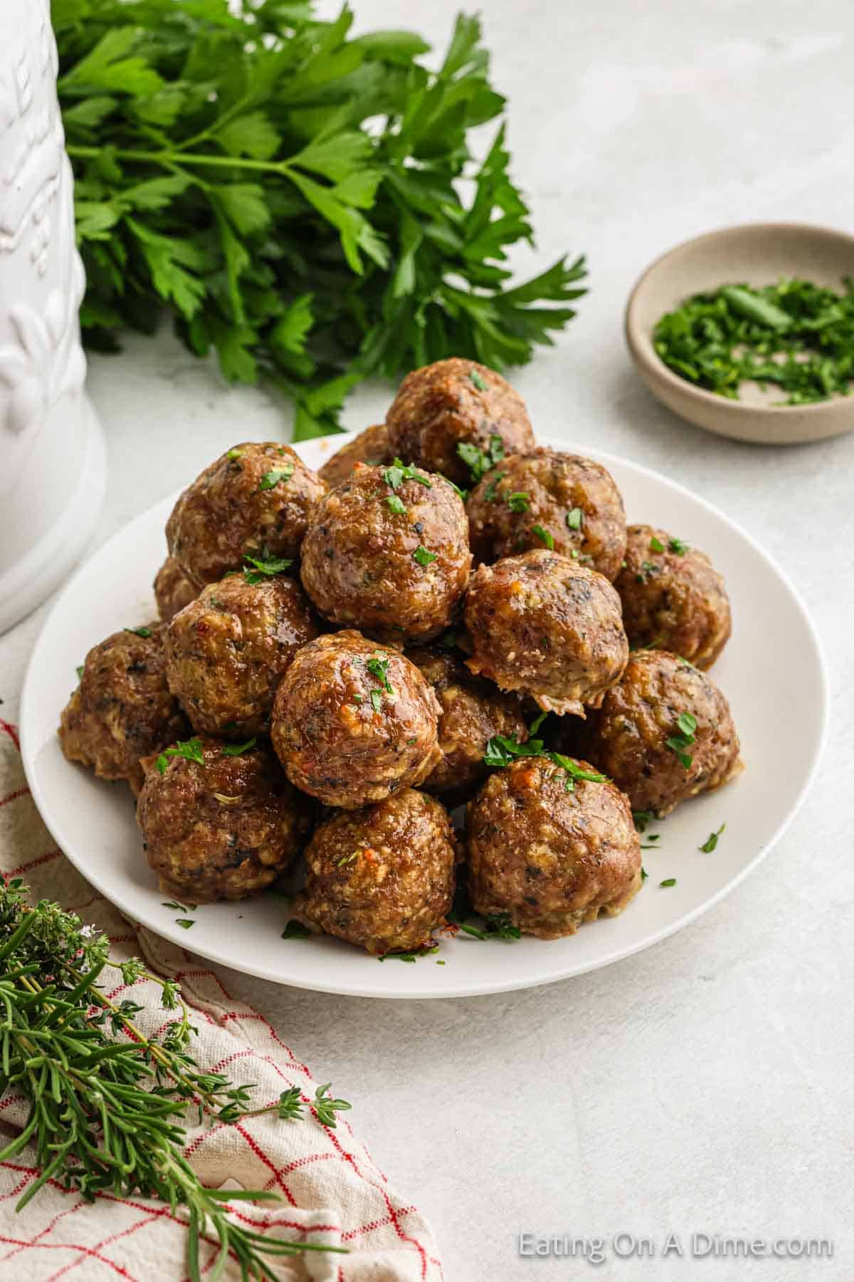 Turkey meatballs stacked on a white plate