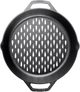 A round cast iron grill pan with two side handles mimics the function of the best grill baskets. Its surface features evenly spaced, teardrop-shaped holes for improved heat distribution and grilling.