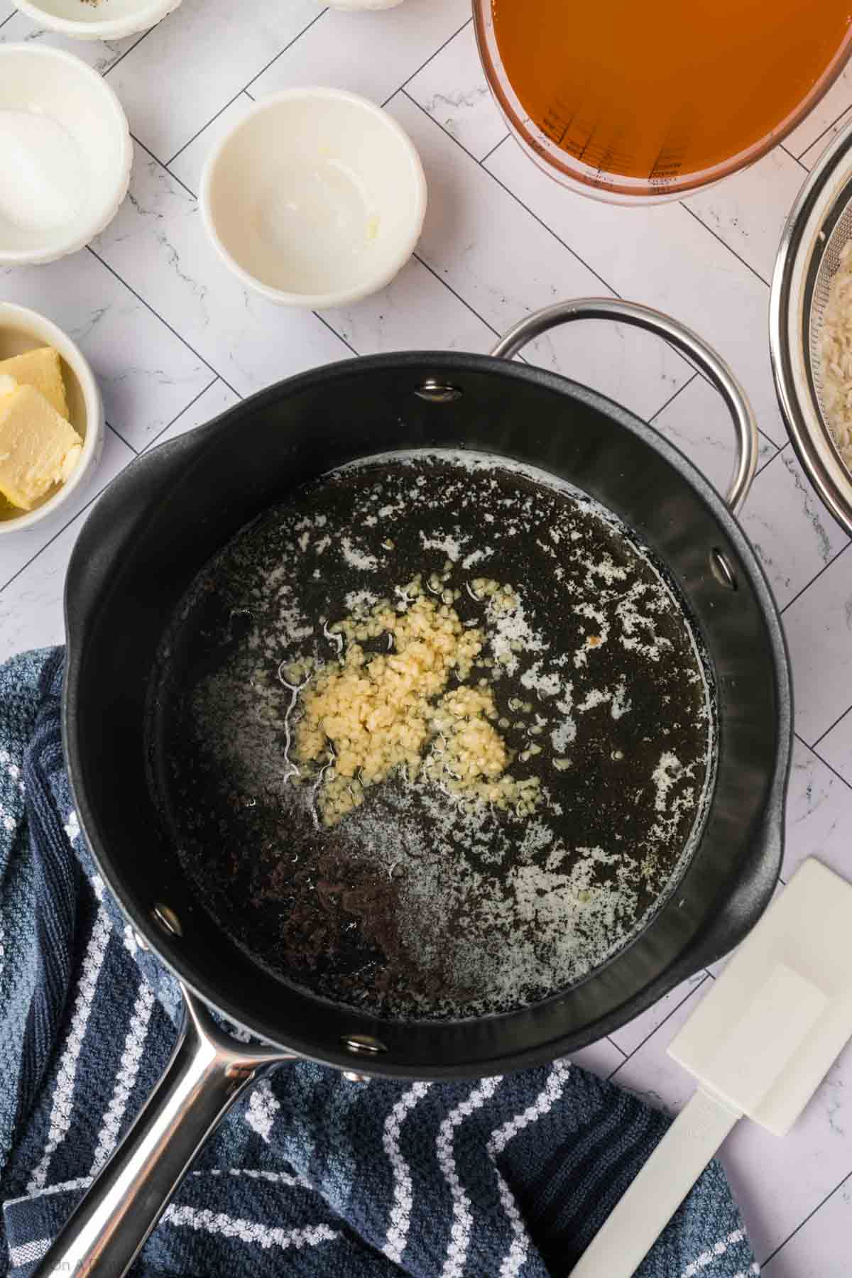 Melted butter in a cast iron skillet with minced garlic 