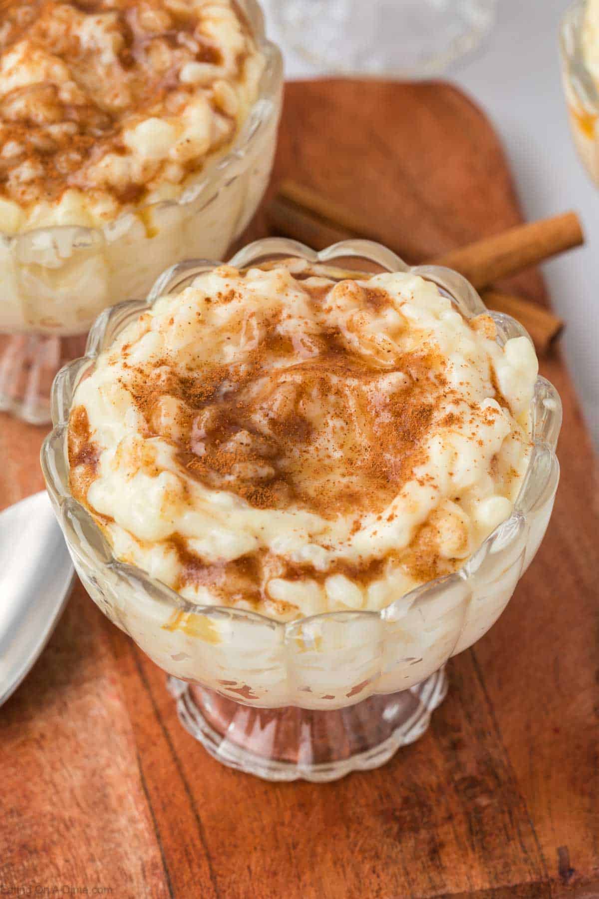 Rice pudding mixture in a clear serving dish topped with brown sugar mixture