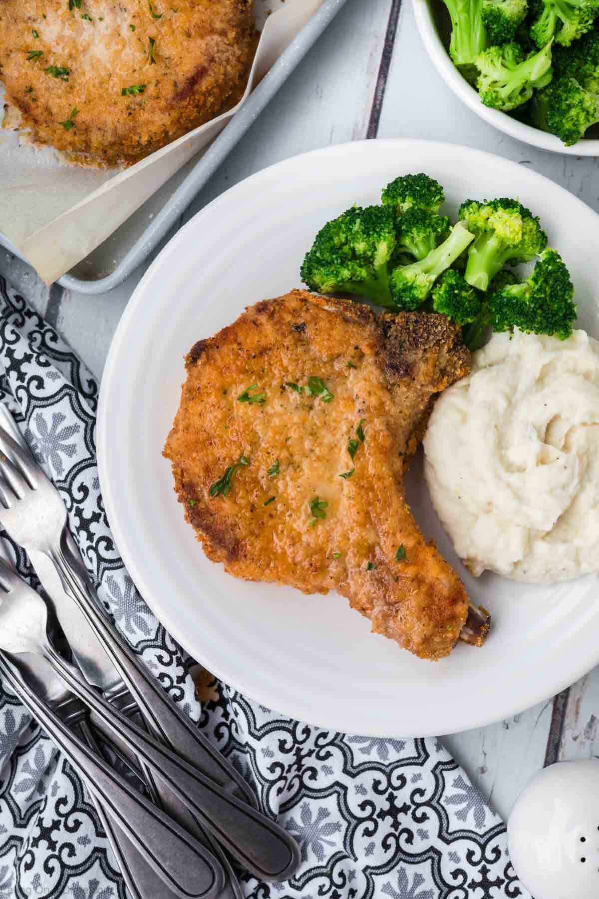 Shake and Bake Pork Chops on a plate with broccoli and mashed potatoes