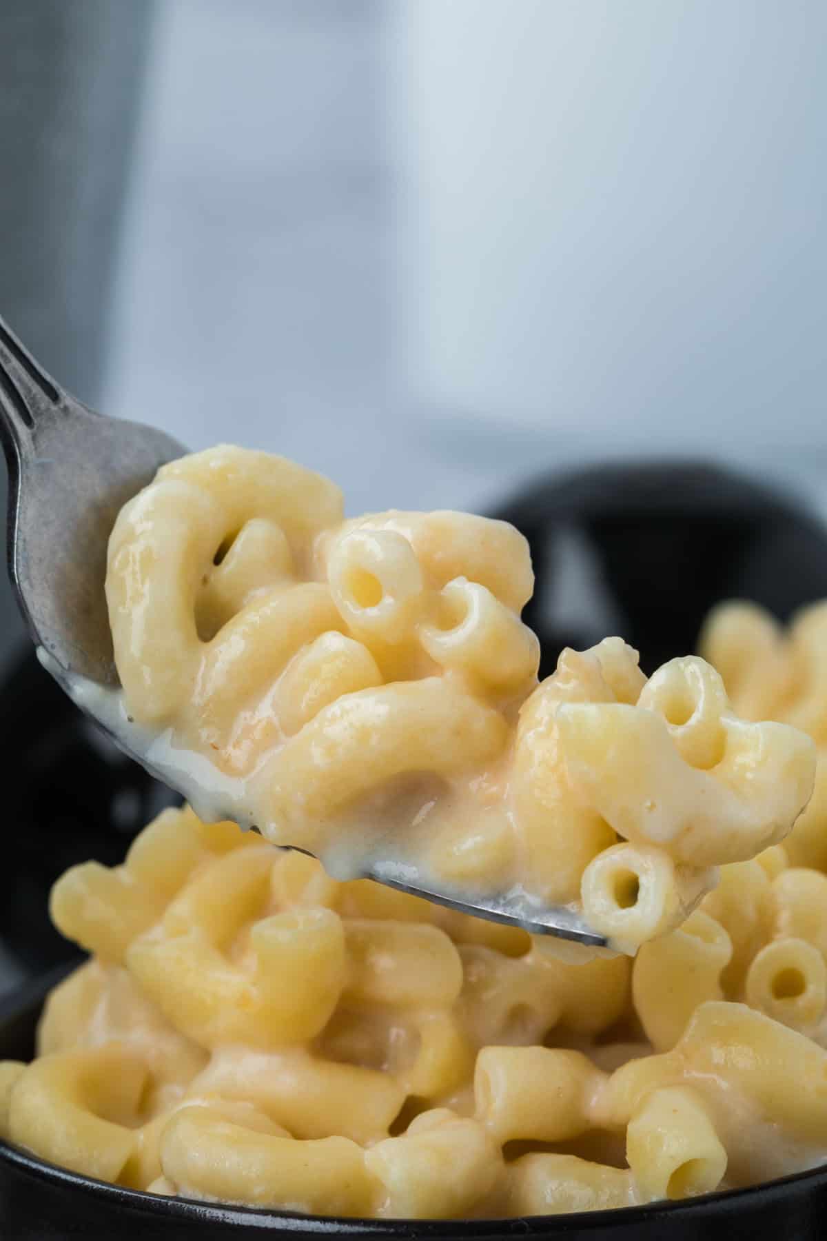 White Cheddar Mac and Cheese in a bowl with a serving on the fork