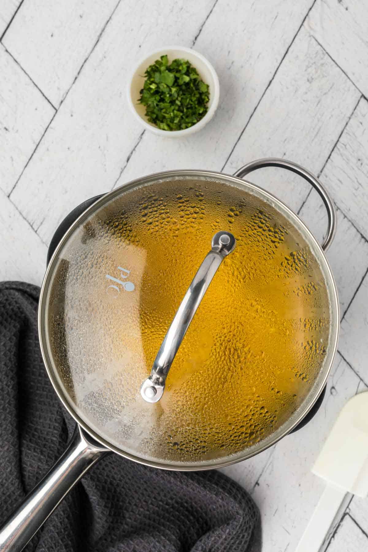 Lid on the saucepan covering the rice mixture 