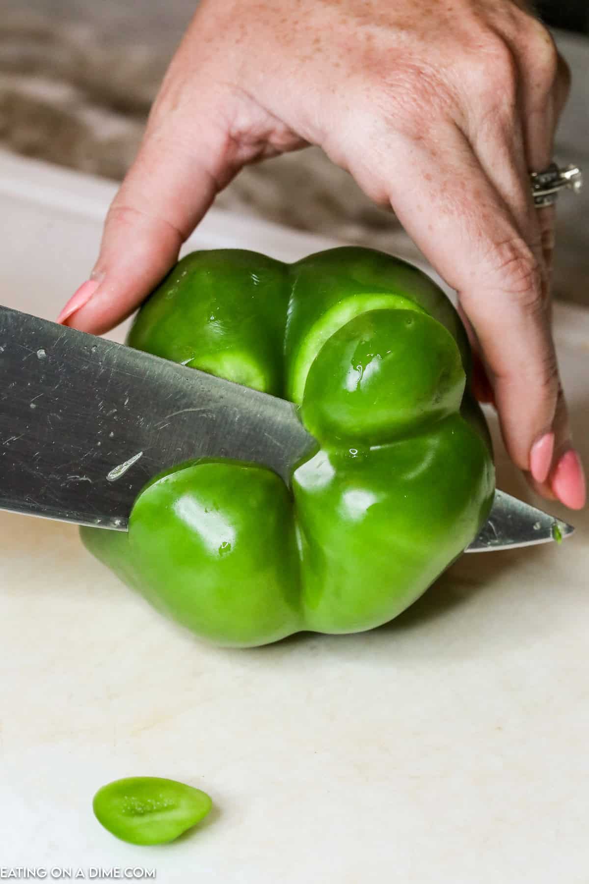 Cutting the bottom of the bell pepper with a knife