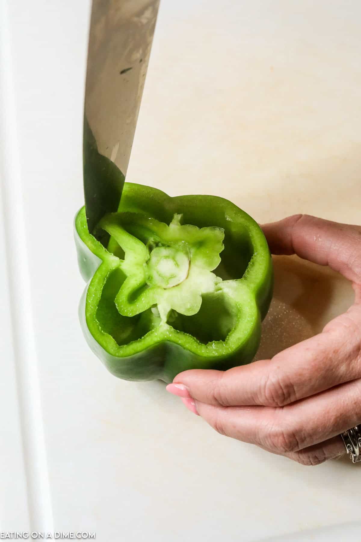 Cutting the inside of the bell pepper with a knife