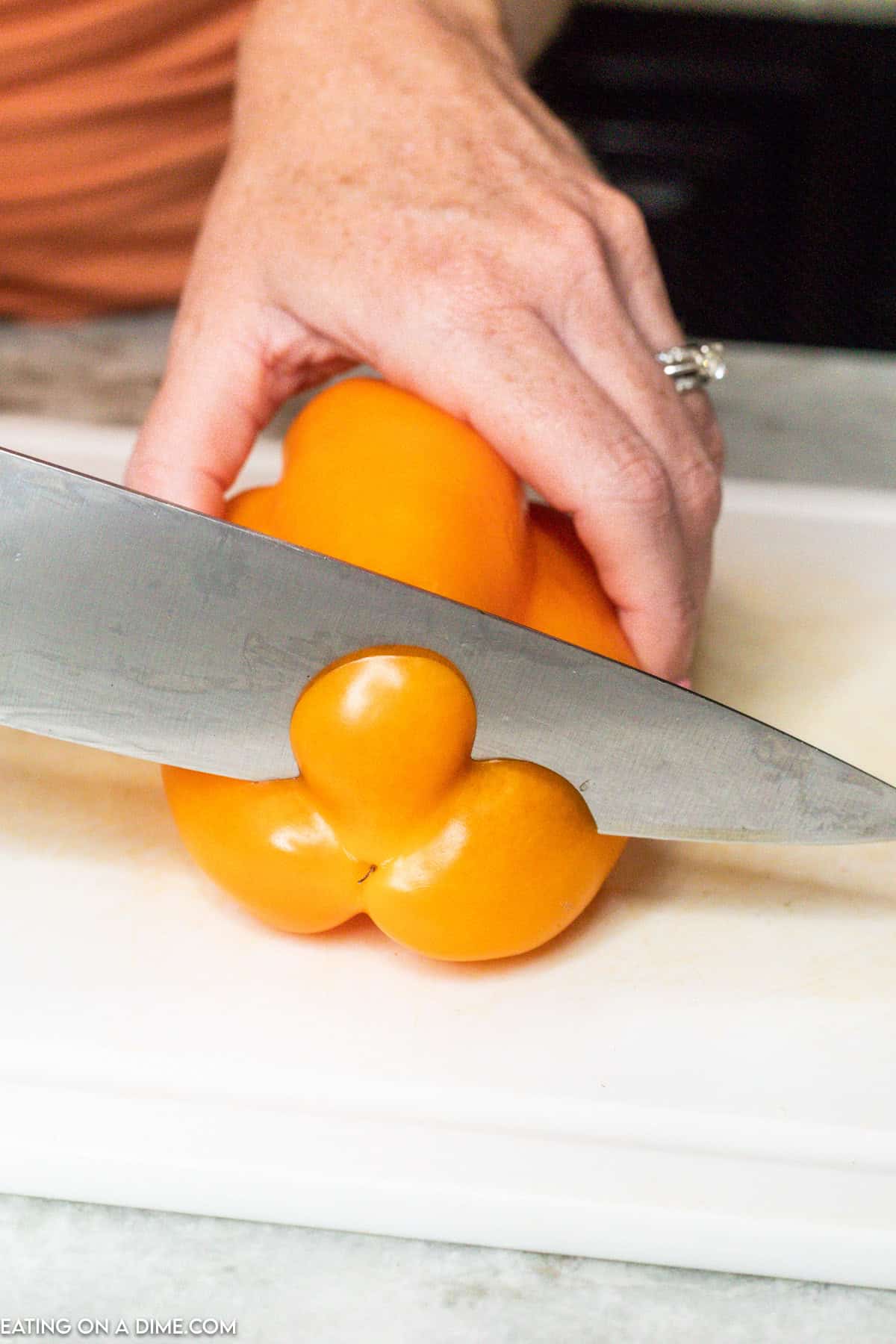 Cutting the bottom of the bell pepper with a knife