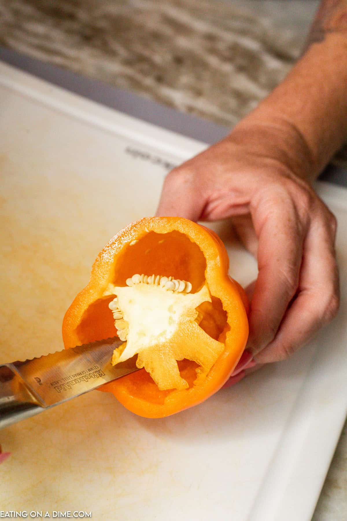 Cutting the inside of the bell pepper with a knife