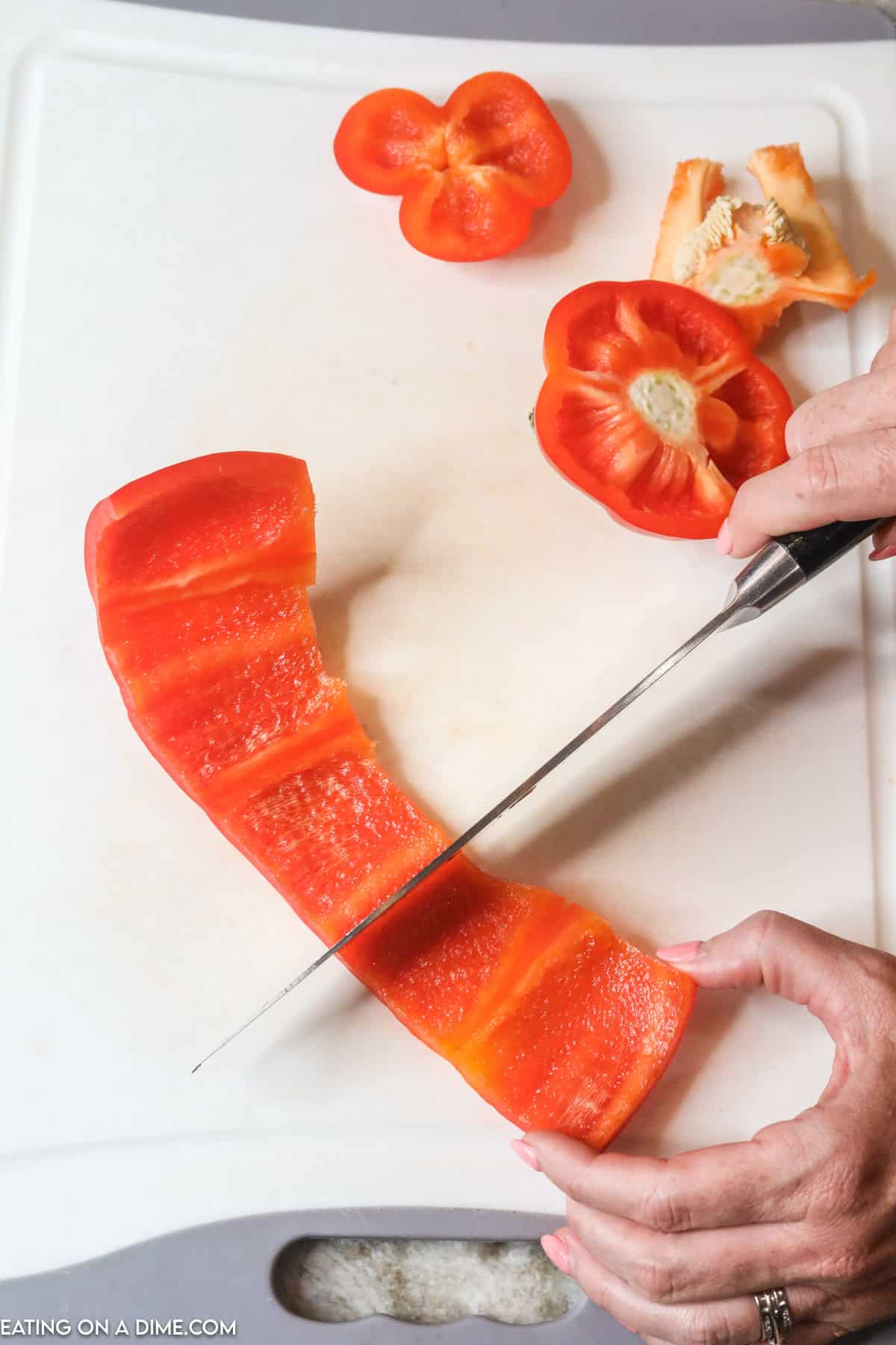 Cutting the red bell pepper into bite size pieces