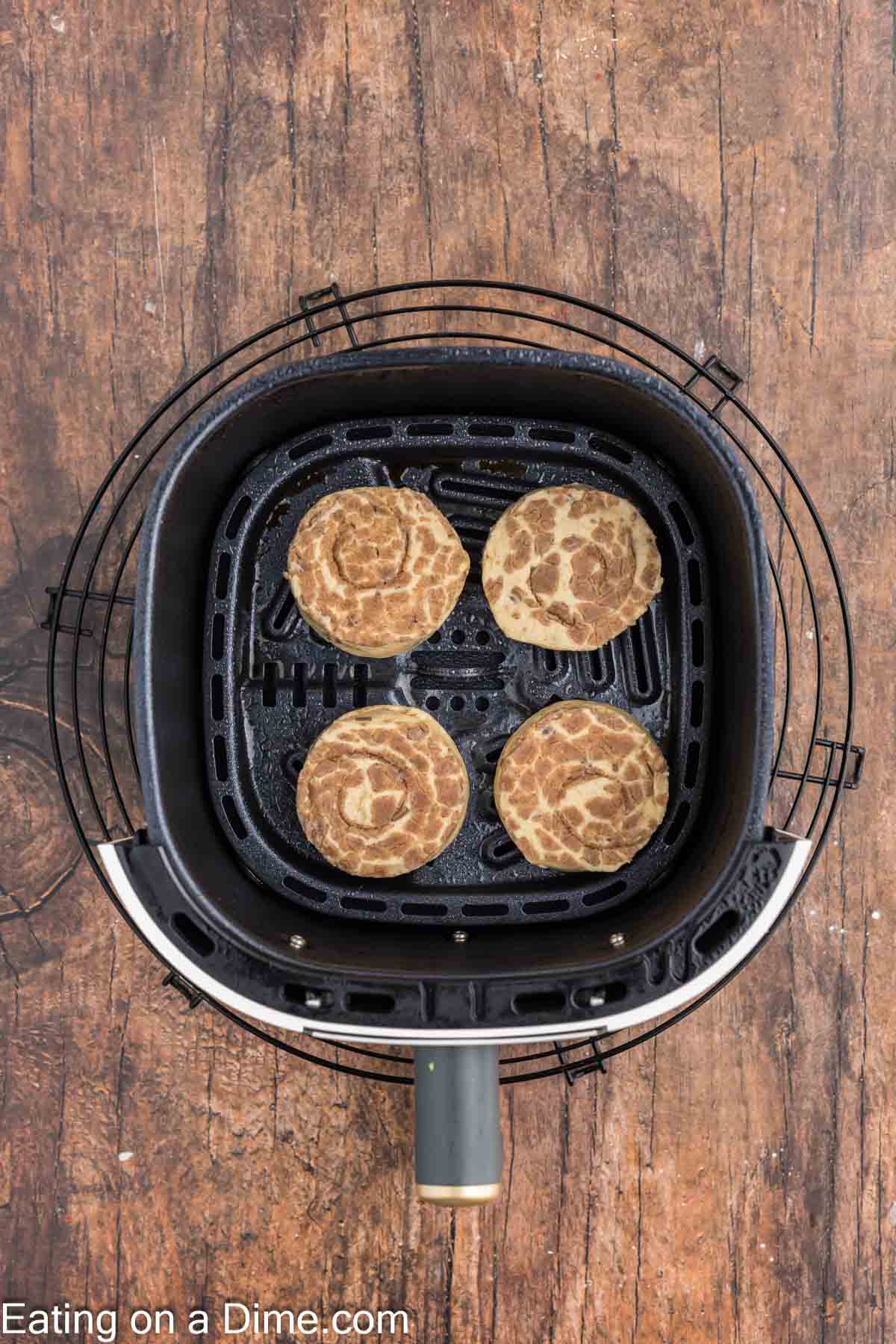 Cinnamon Rolls placed in the air fryer basket