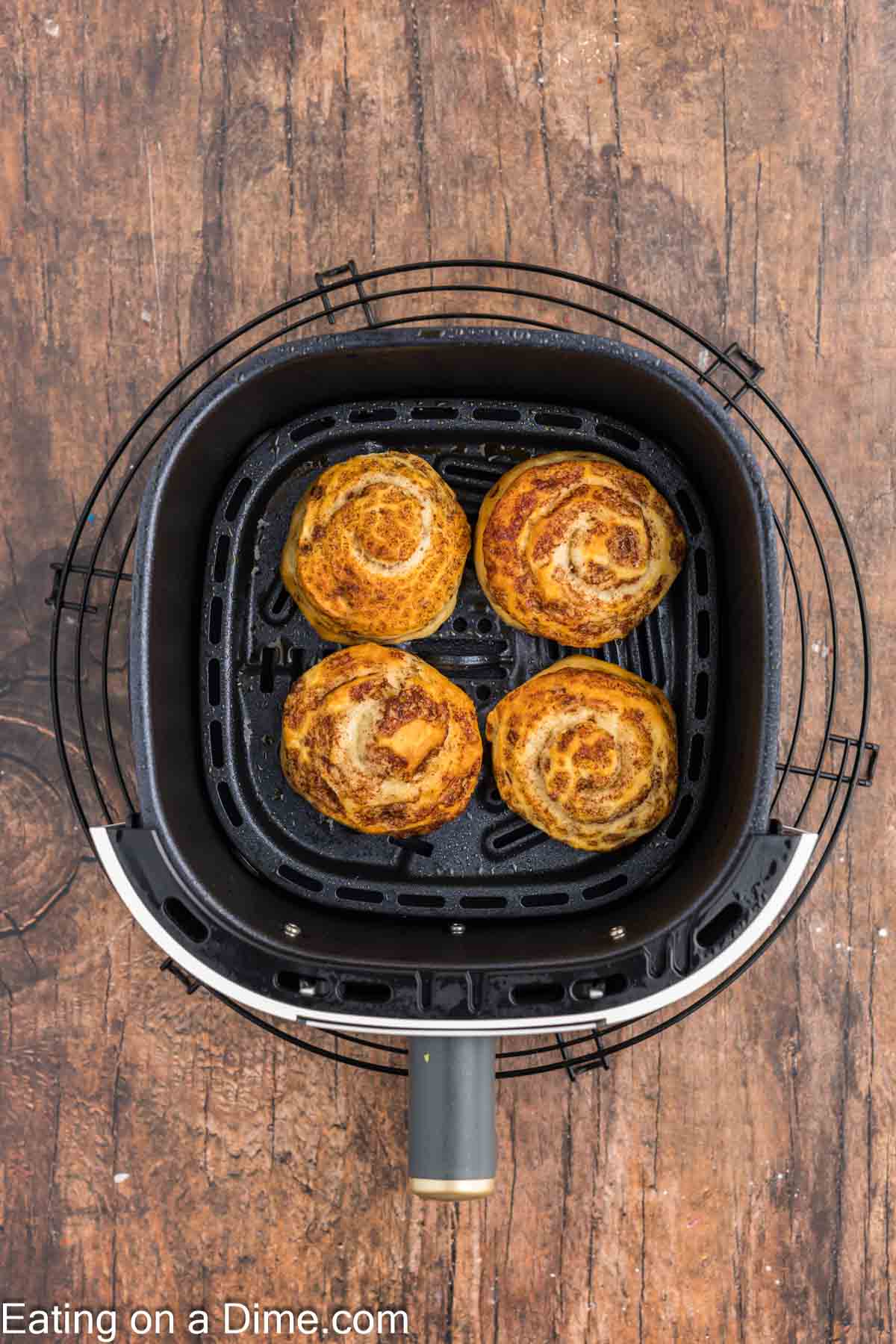 Cooked Cinnamon Rolls in the air fryer basket