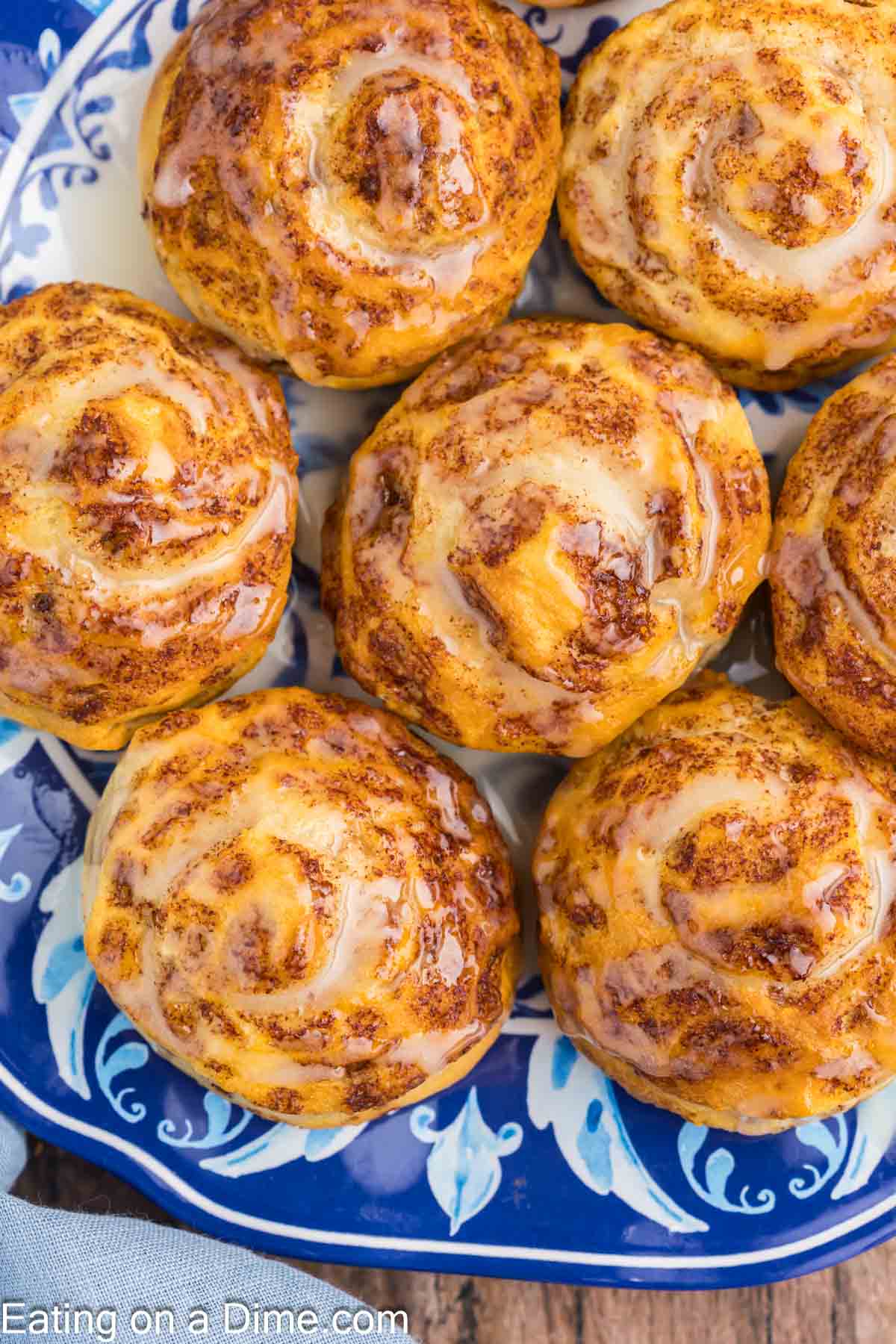 Cinnamon Rolls topped with icing on a plate