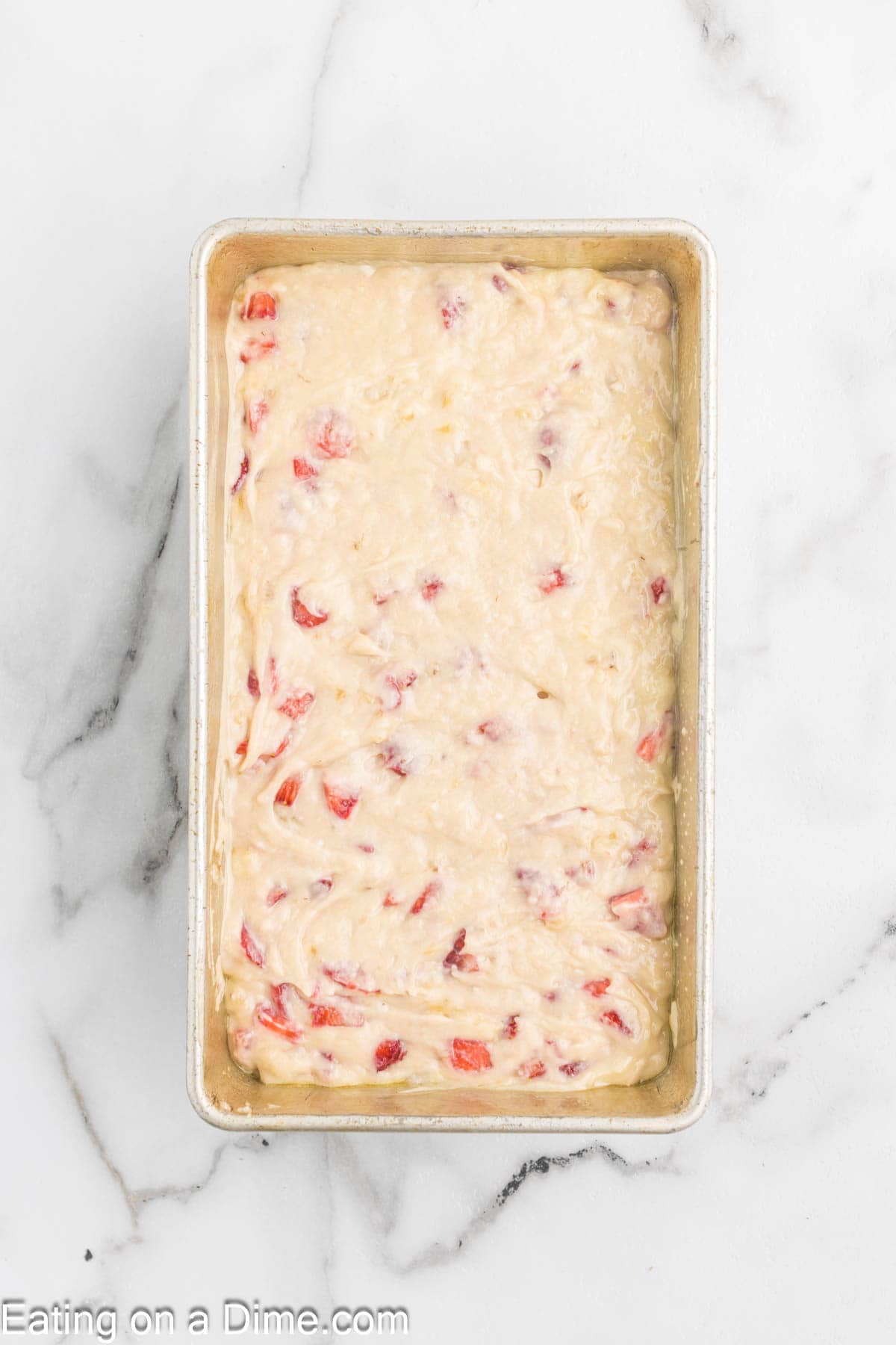 Pouring the bread batter in the loaf pan