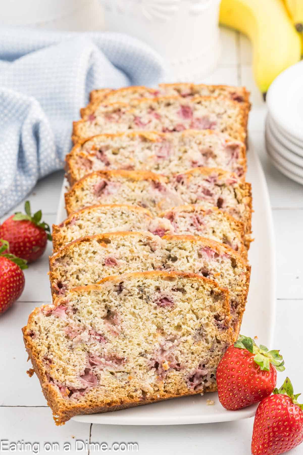 Sliced strawberry and banana bread on a platter