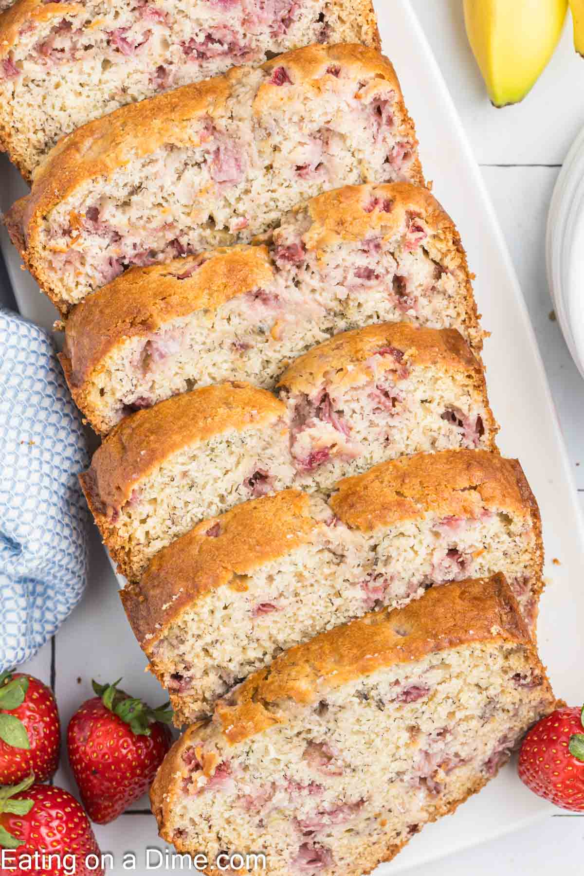 Strawberry and banana bread sliced on a platter