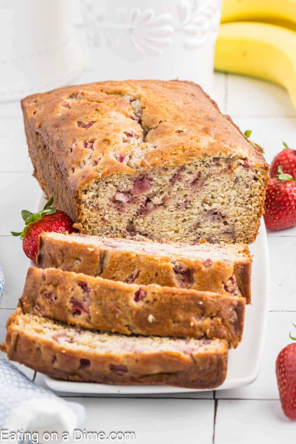 Strawberry banana bread sliced and on a platter