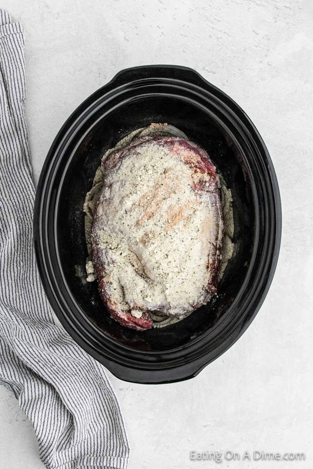 Seasoning mix topped the pork roast in the slow cooker