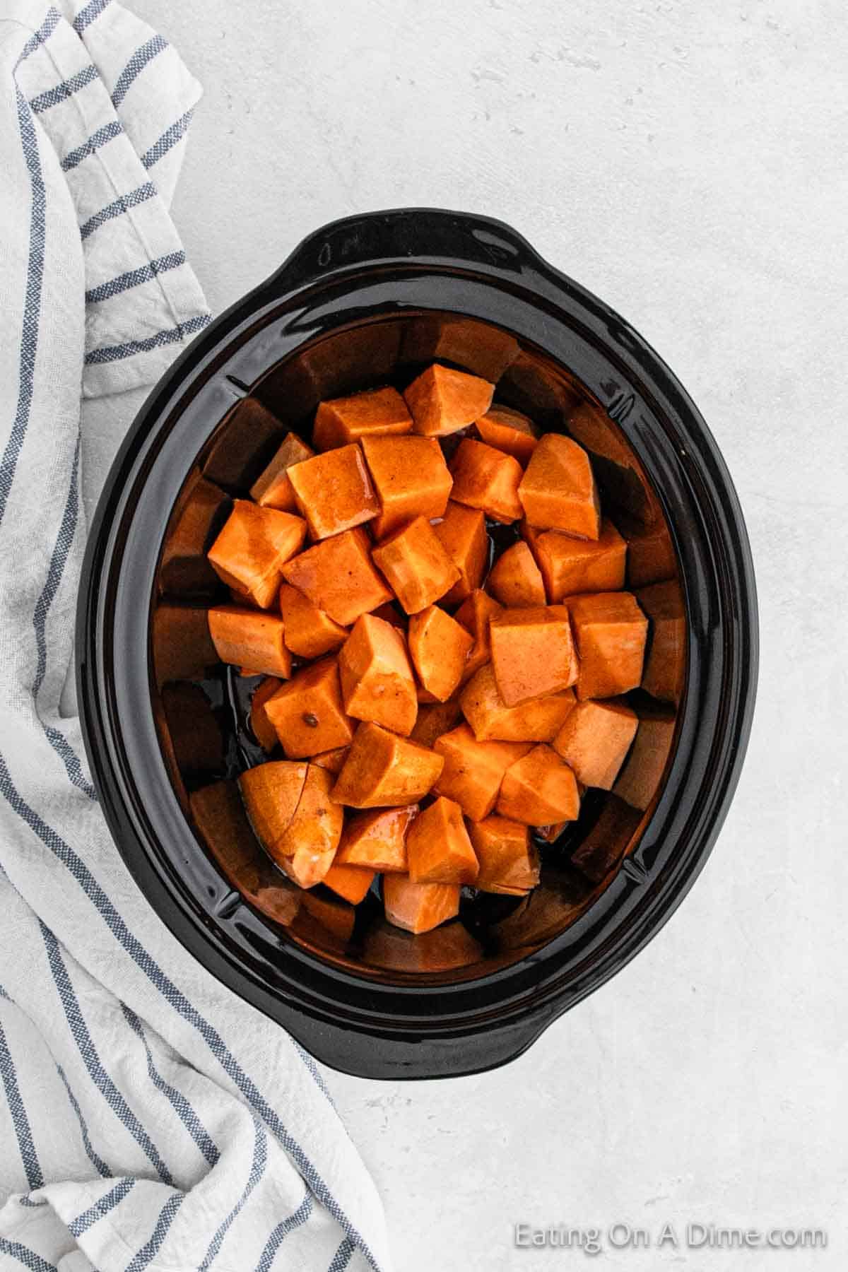 Brown sugar glaze poured over the sweet potatoes in the slow cooker