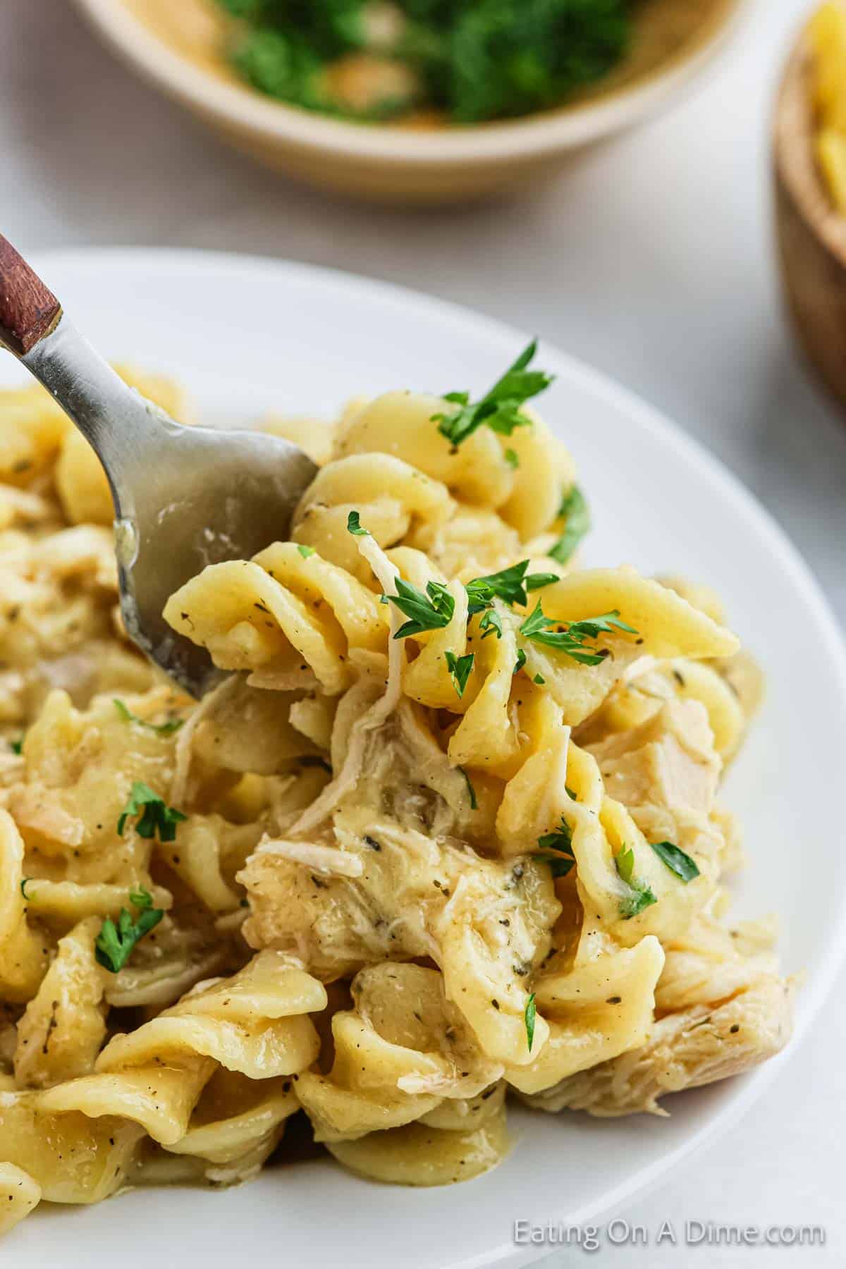 Chicken and Noodles on a plate with a bite on a fork