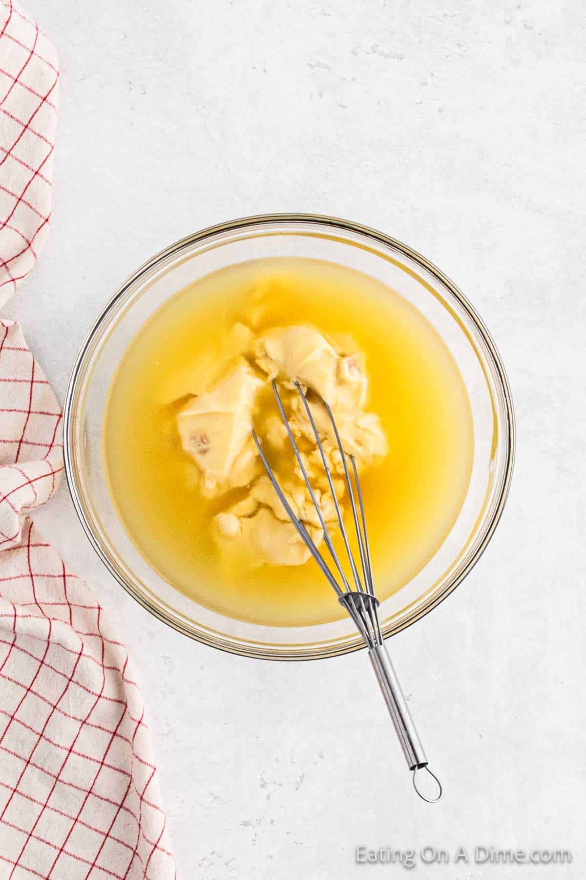 Whisking together cream of chicken soup and broth together in a bowl