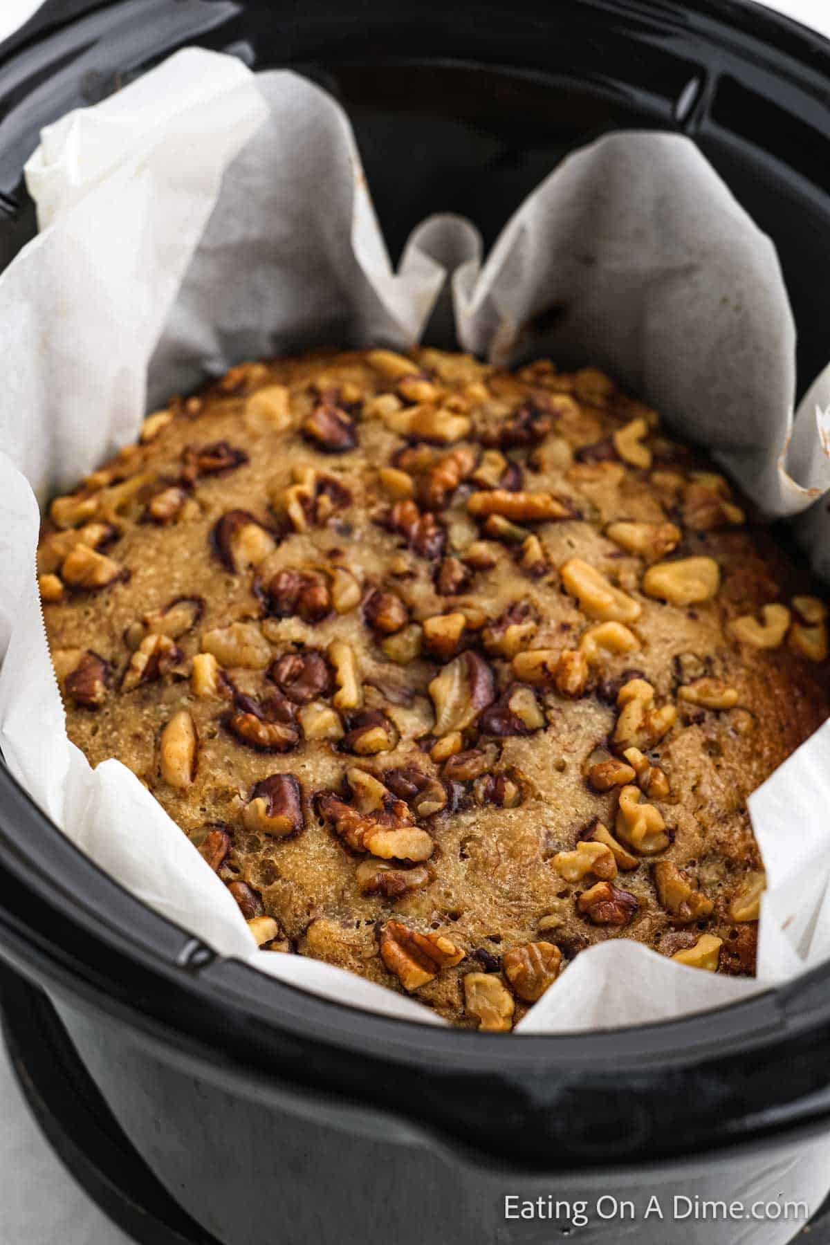 Banana Bread cooked in the slow cooker lined with parchment paper