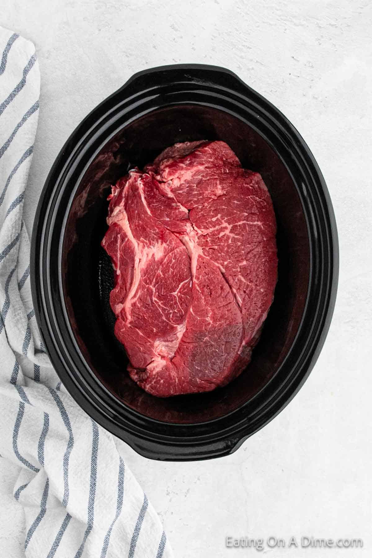 Placing roast in the slow cooker