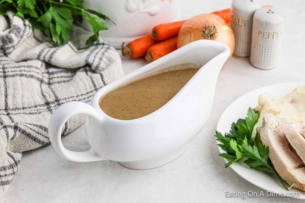 Brown turkey in a white ladle with a side plate of sliced turkey