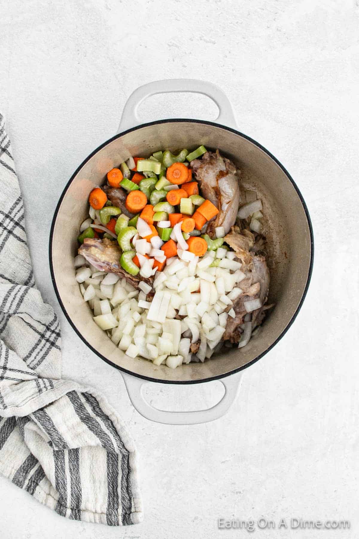 Chopped carrots, celery and onions in the large pot with the turkey neck and backbone