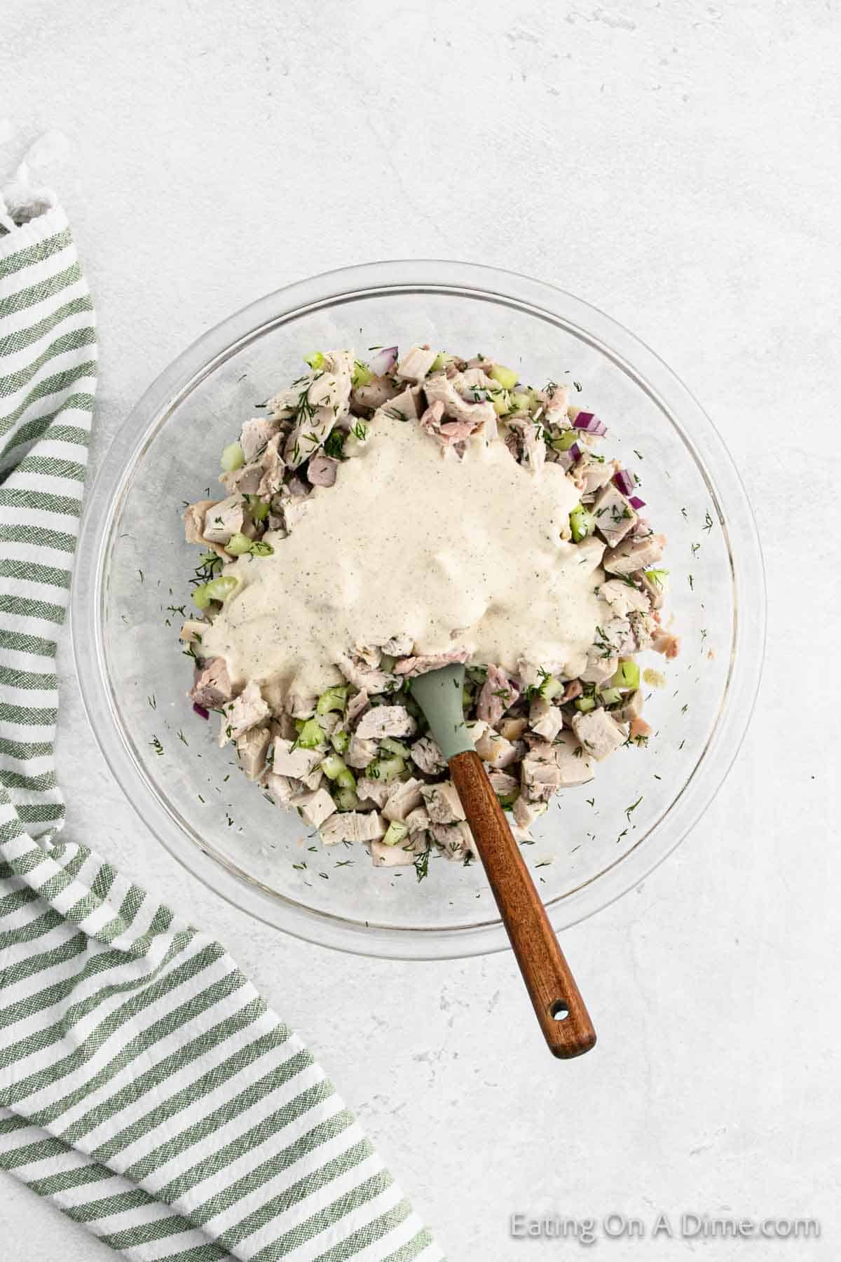 Mayonnaise mixture topped with turkey mixture in a bowl