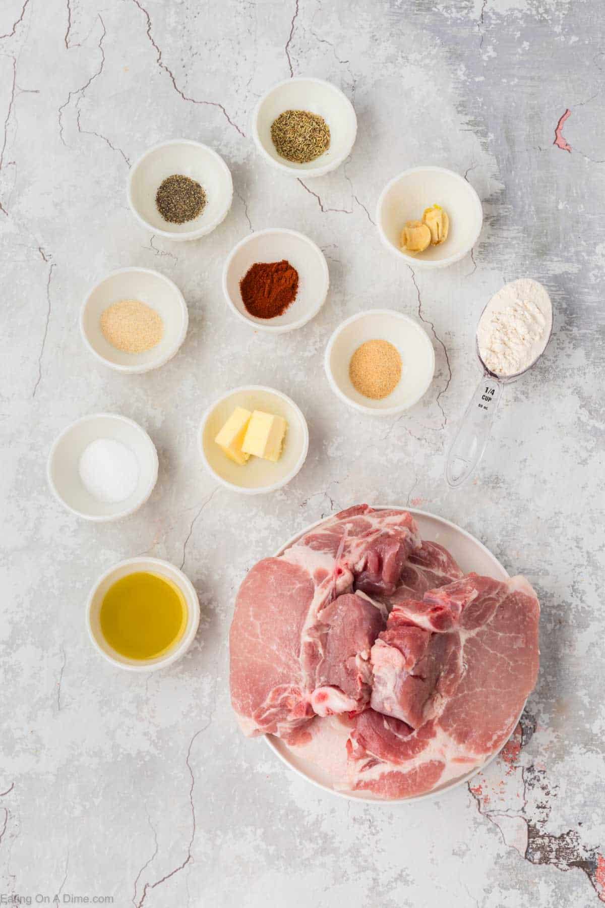 Ingredients - Bone-In Pork Chops, olive oil, butter, rosemary, garlic powder, onion powder, paprika, salt, pepper, flour, garlic