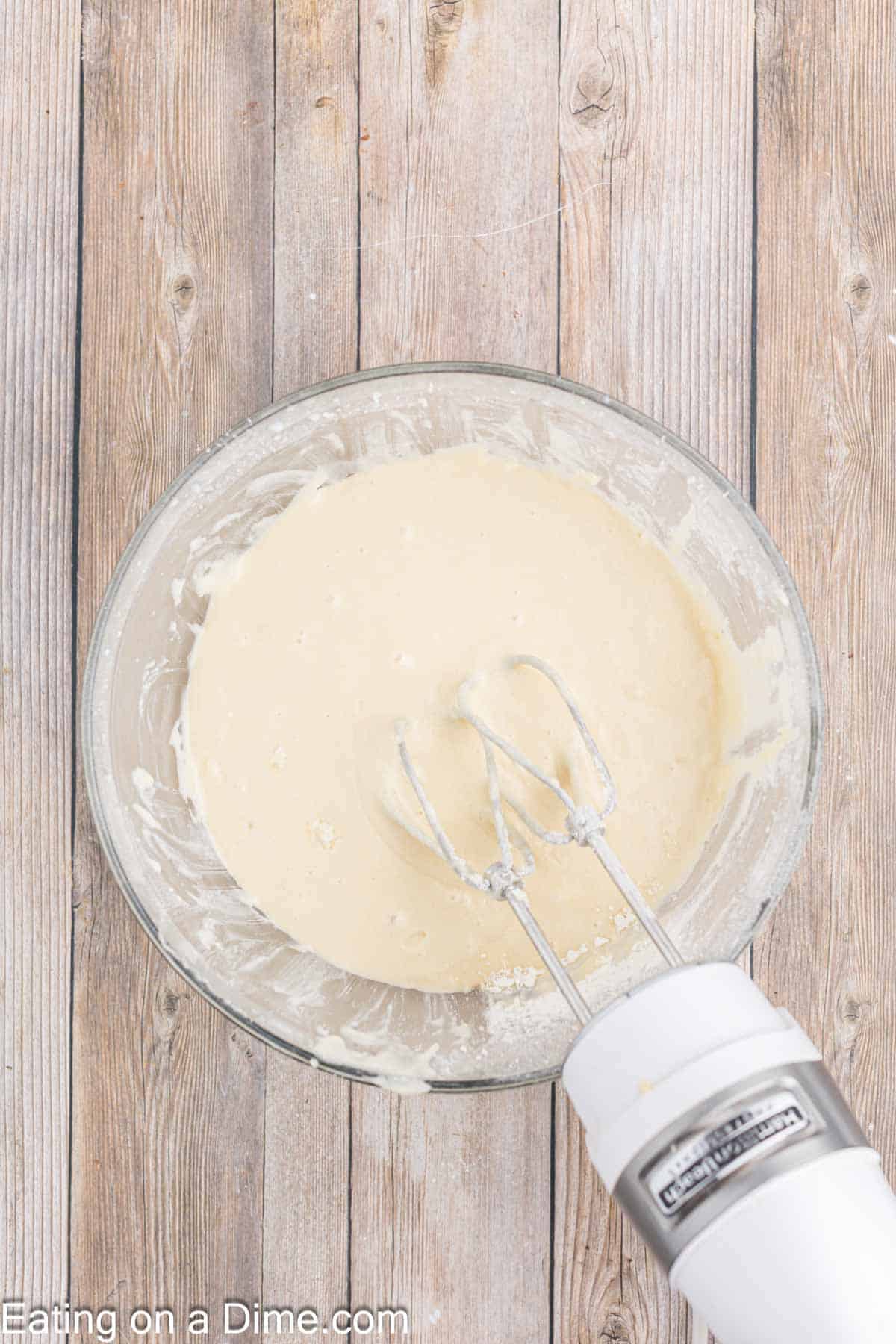 Flour mixture and butter mixture blended together in a large bowl with a mixer