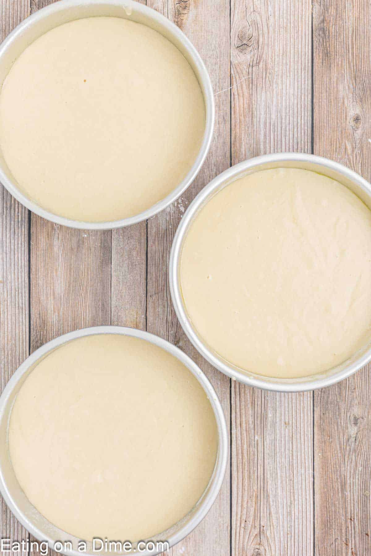 Vanilla Cake Batter divided into round cake pans