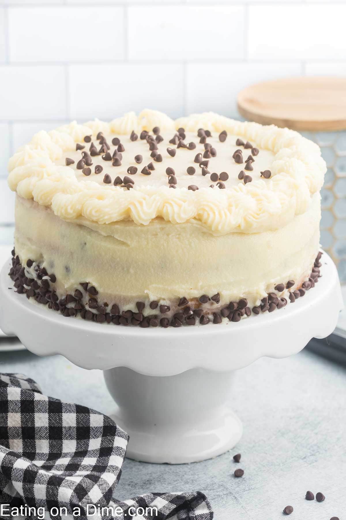 Whole Cannoli Cake topped with chocolate chips on a cake pan