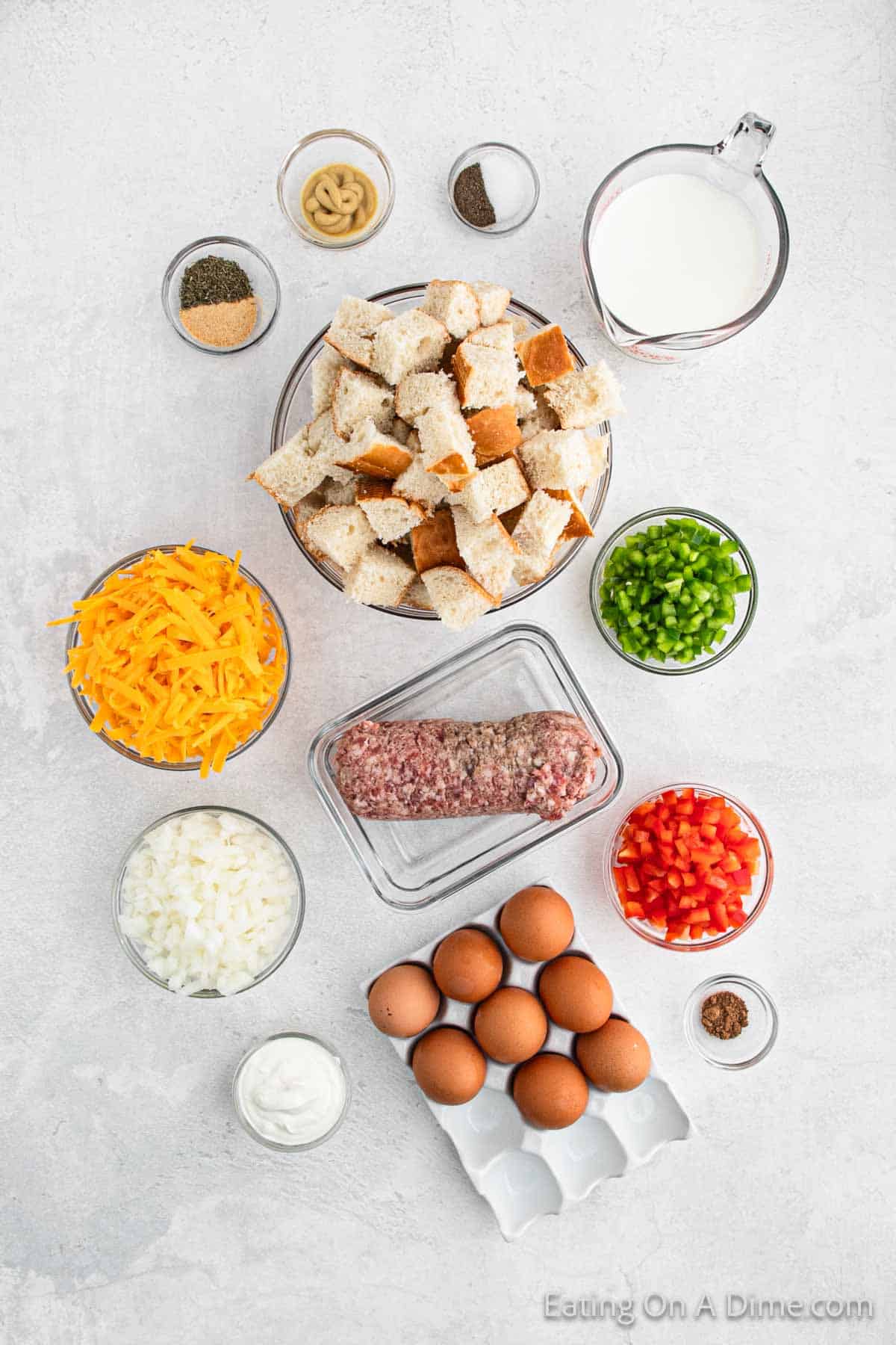 Ingredients - French bread, breakfast sausage, red bell pepper, green bell pepper, onion, shredded cheese, eggs, milk, sour cream, Dijon Mustard, garlic powder, dried thyme, salt, pepper, nutmeg, fresh parsley