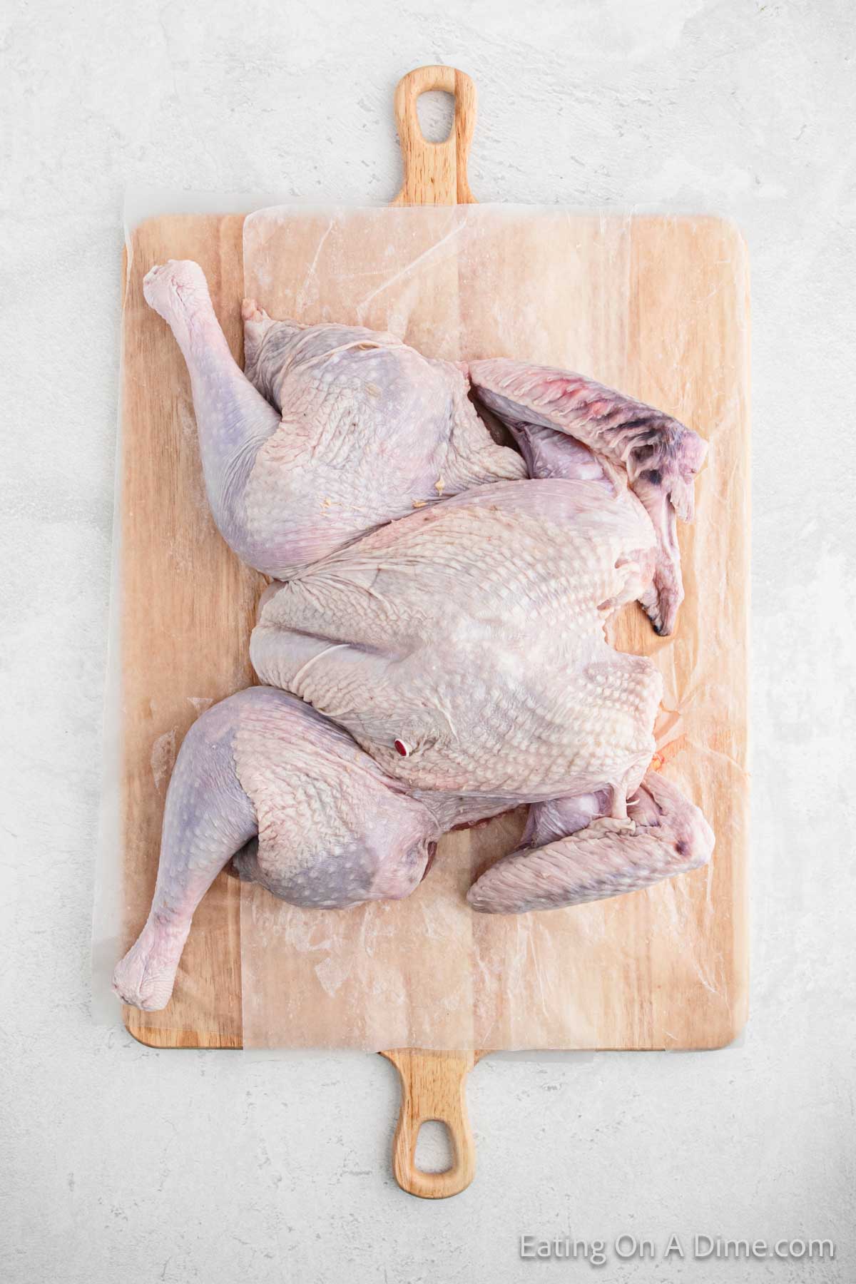 Whole turkey flattened on a cutting board