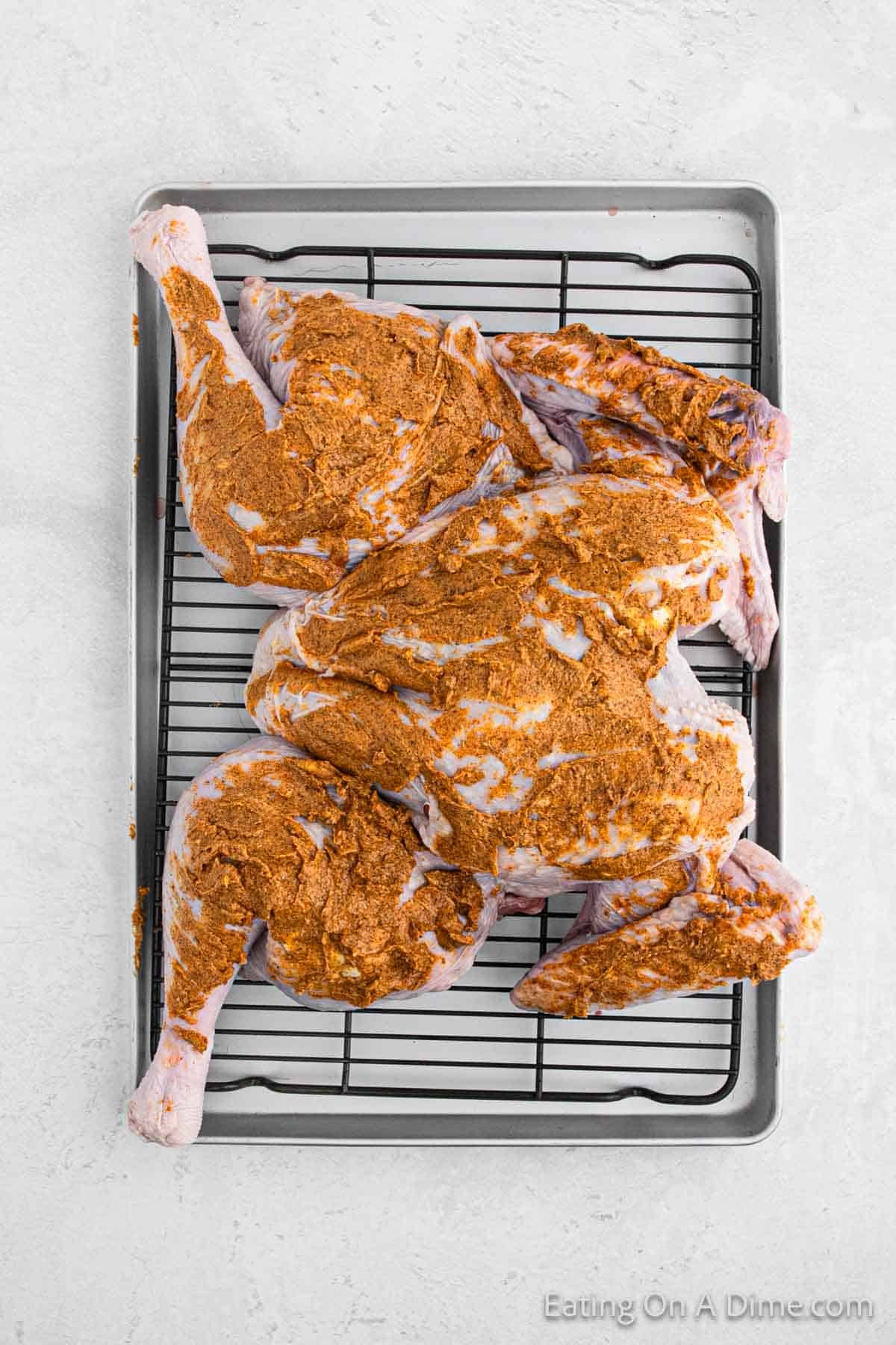 Butter and seasoning mixture spread over the turkey on a baking pan