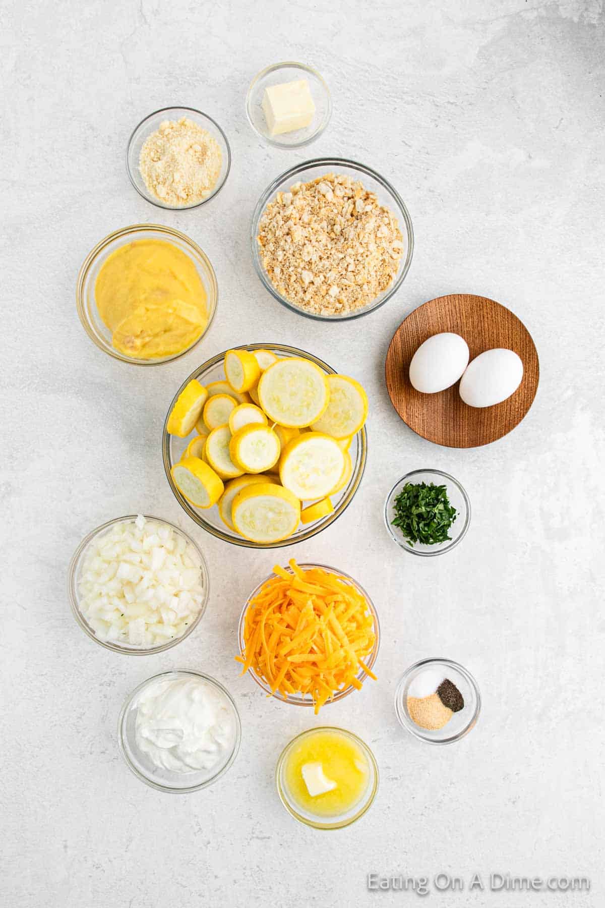 Ingredients - Yellow Squash, onion, cheddar cheese, sour cream, cream of chicken soup, eggs, butter, garlic powder, salt, pepper, fresh parsley, butter crackers, grated parmesan cheese