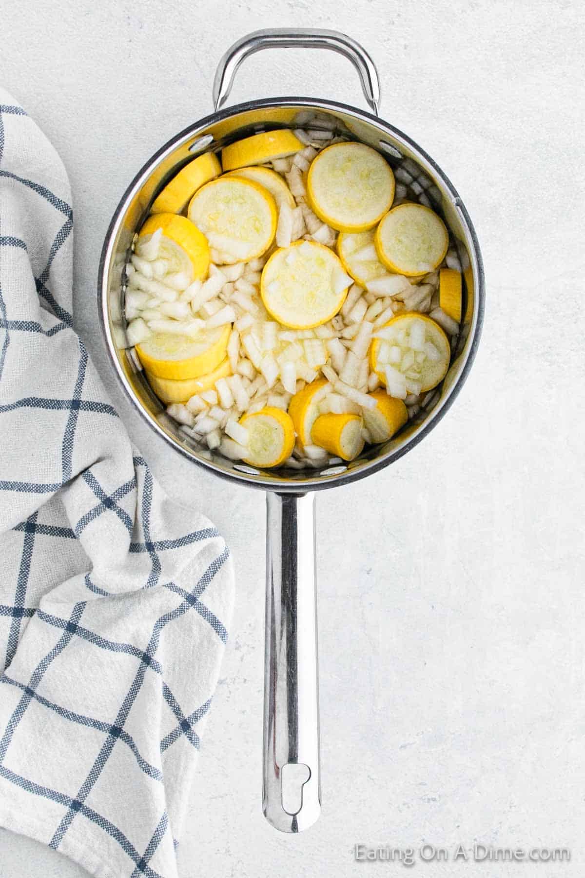 Slice squash in a large pot with chopped onions