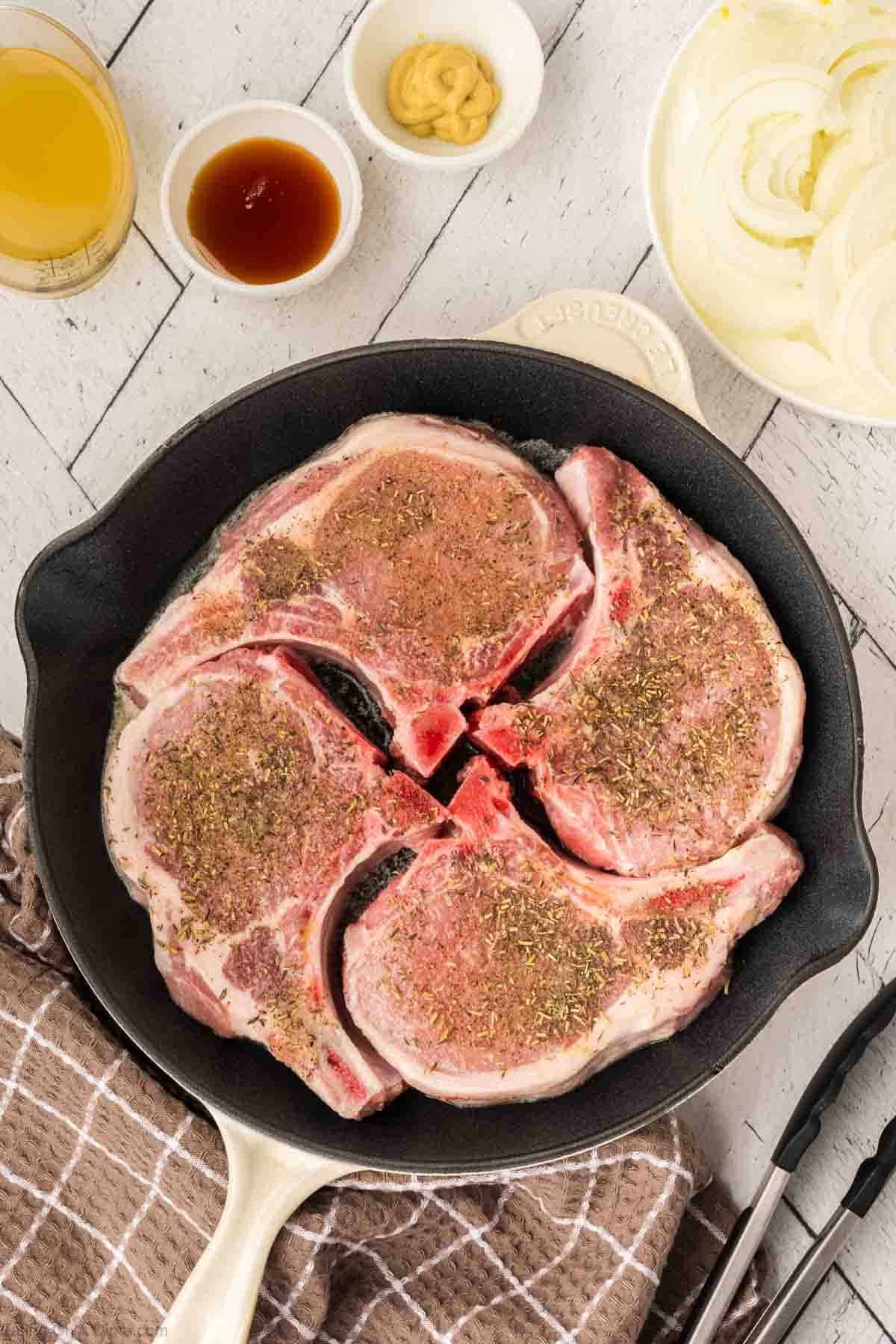 Place the seasoned pork chops in a skillet