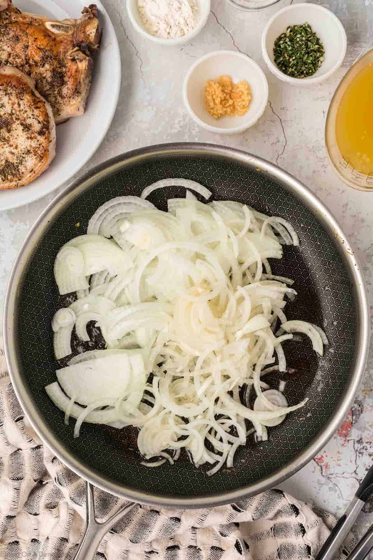 Sliced onions in a skillet