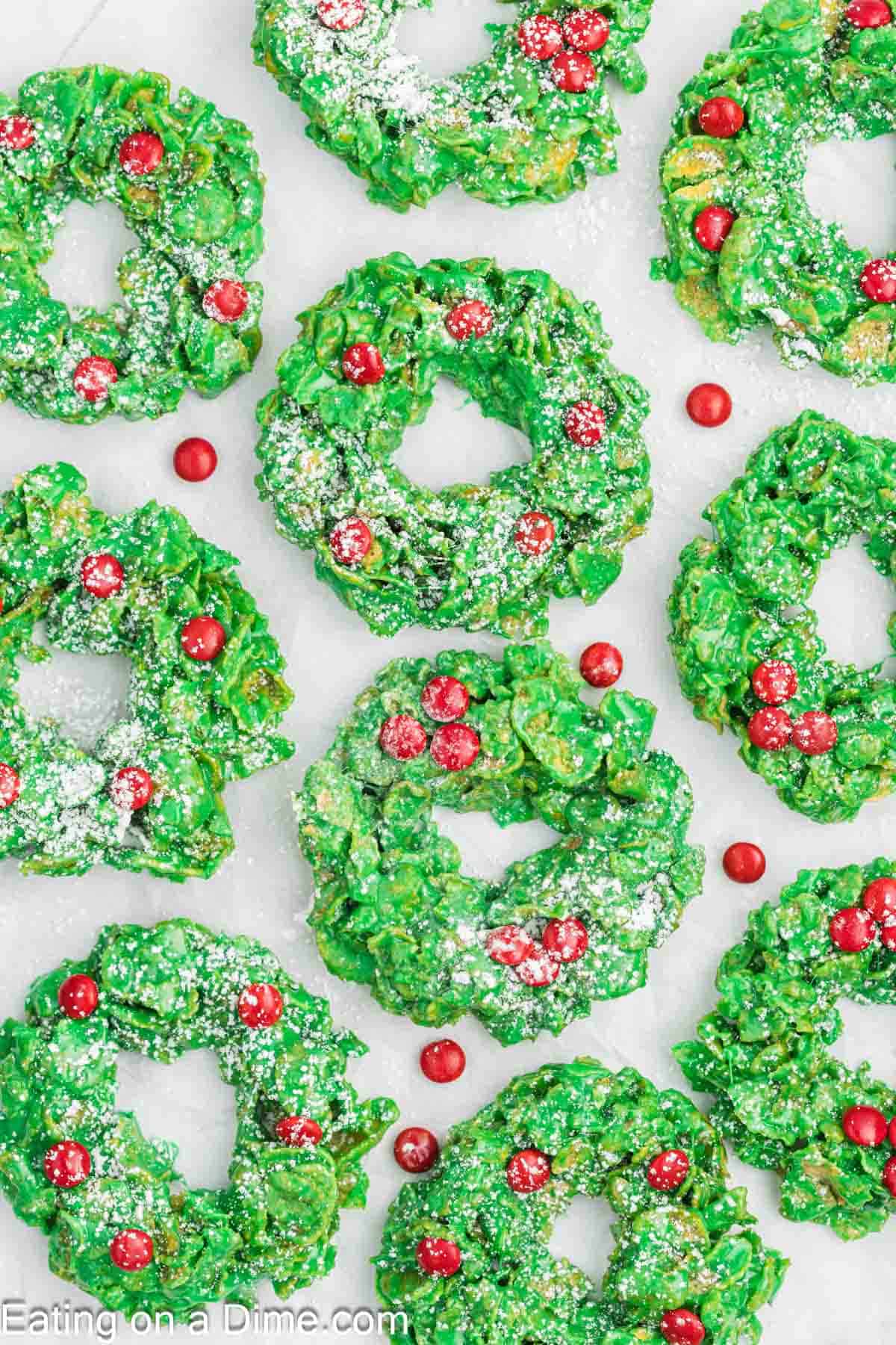 Christmas Wreath Cookies dusted with powdered sugar and topped with red candies