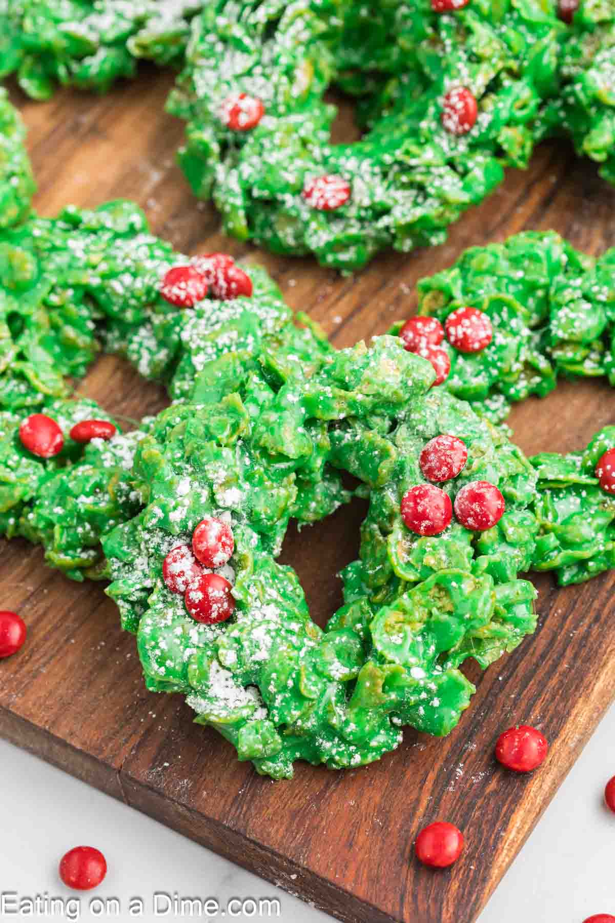 Christmas Wreath Cookies dusted with powdered sugar and topped with red heart candies