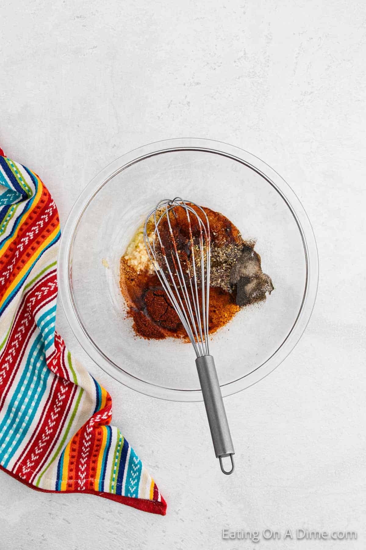 Combining the marinade ingredients in a bowl with a whisk