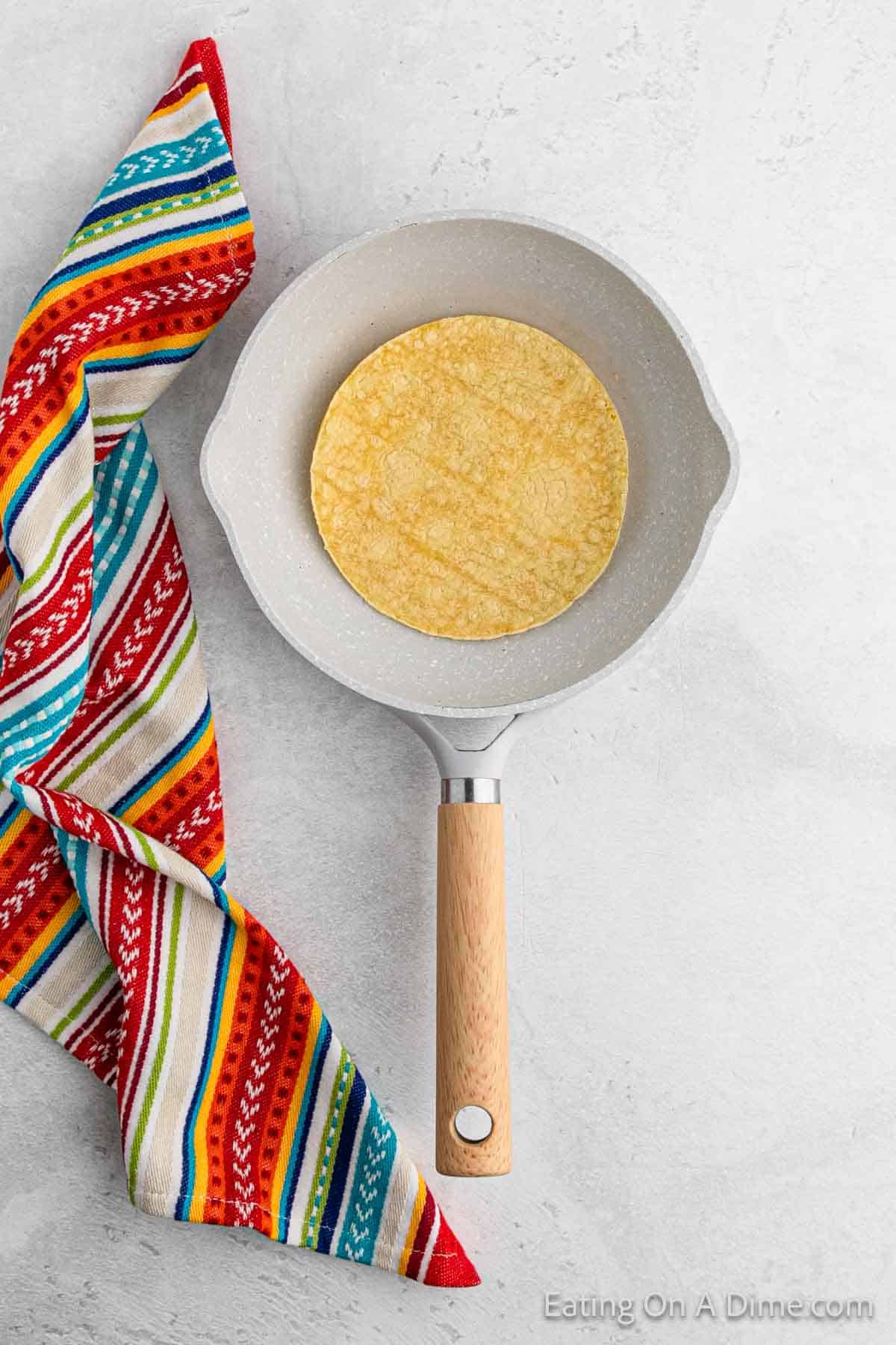 Warming corn tortilla in a skillet