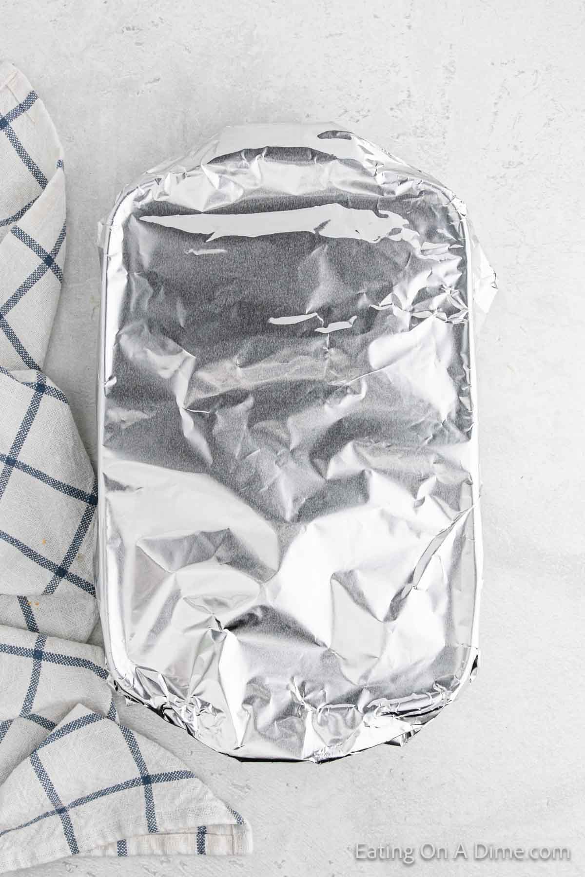 Baking dish topped with aluminum foil