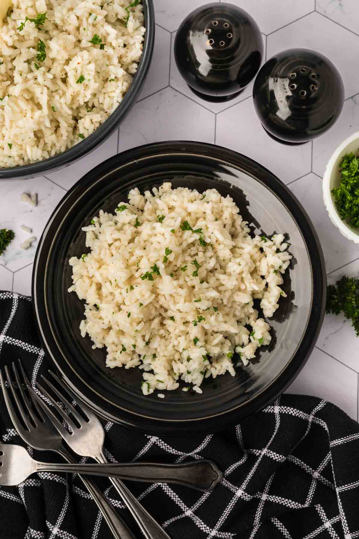 White rice on a plate topped with parsley