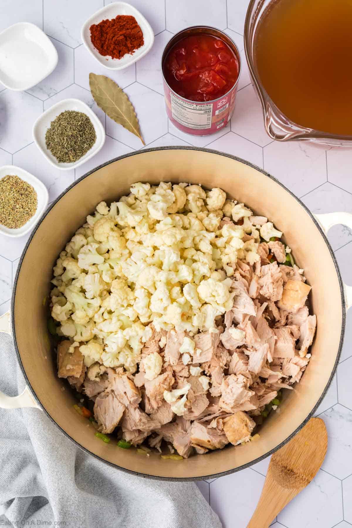 Chopped cauliflower and shredded cooked turkey in a large pot