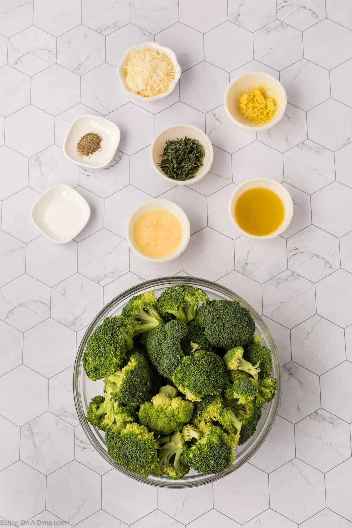 Ingredients - Broccoli Florets in a bowl, olive oil, butter, lemon zest, thyme leaves, parmesan cheese, salt, pepper