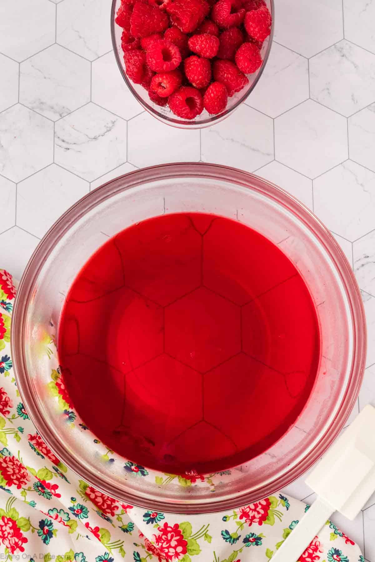 Raspberry gelatin in a bowl with water